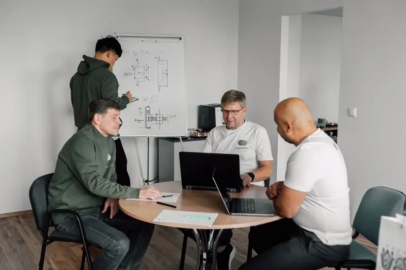 Engineerly engineers in a technical discussion at the Tallinn office.